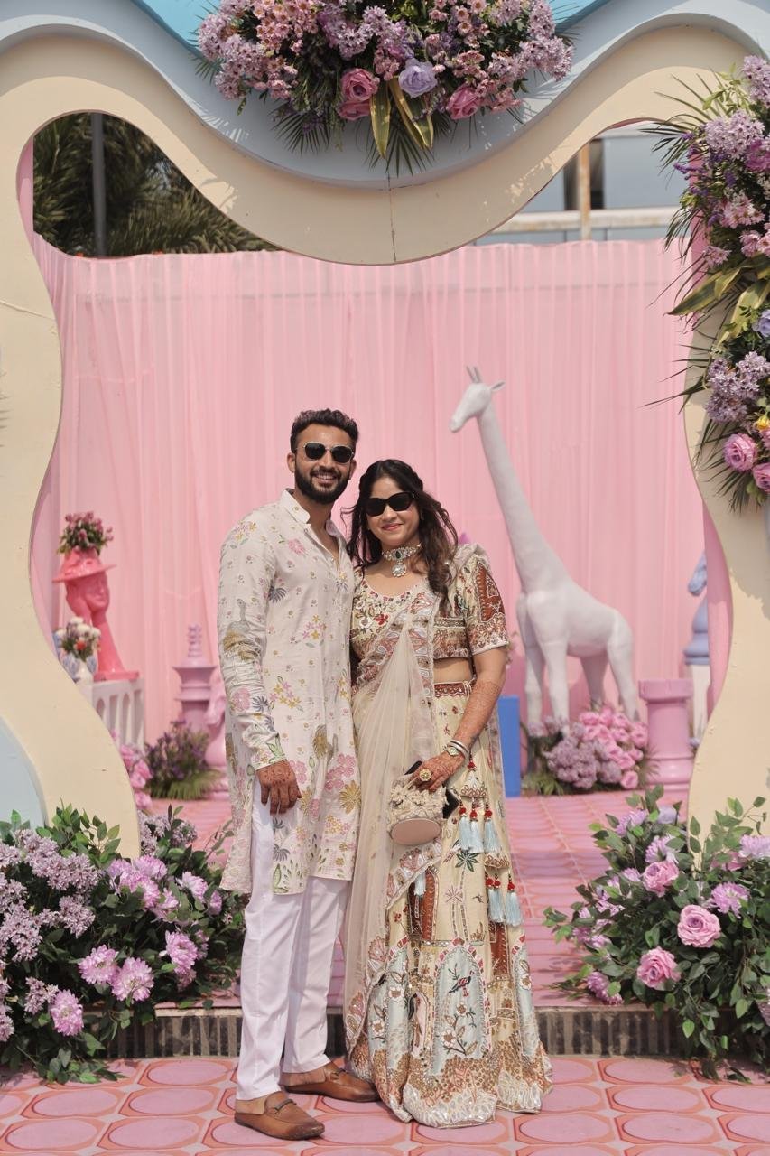 Ankit and Prisha under a floral arch